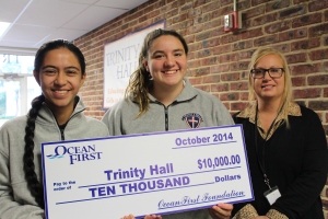 Student body president Pallavi K., vice president Abby M. and STEM teacher Kali Lambrou accept the $10,000 Ocean First Bank Grant on behalf of the school.
